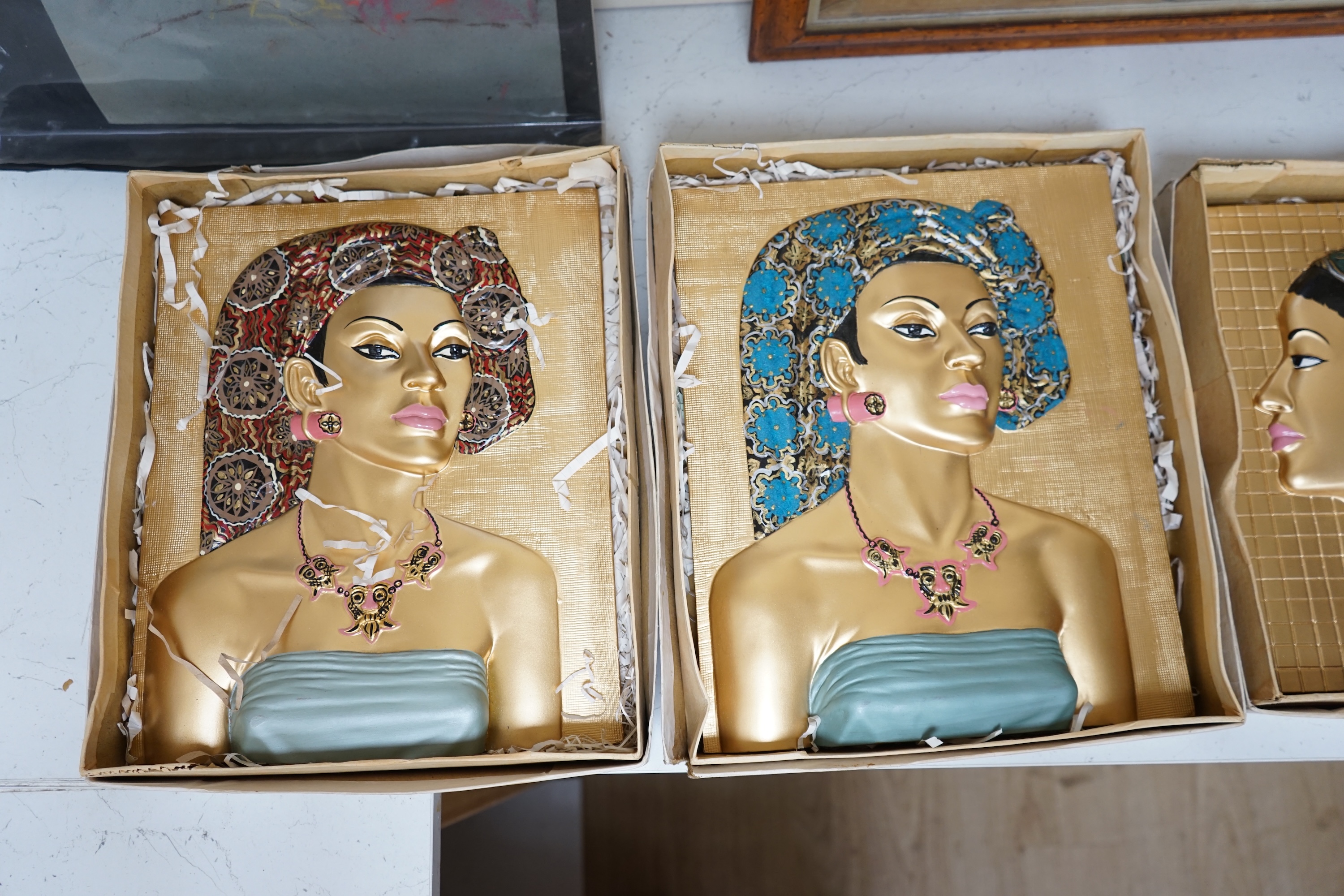 Five moulded and hand painted plaster plaques, busts of women, in original boxes, 35cm high. Condition - good